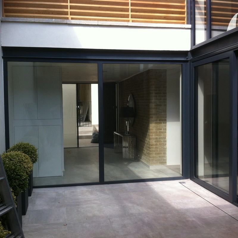 Floor-to-ceiling sliding doors opening to courtyard in Slough